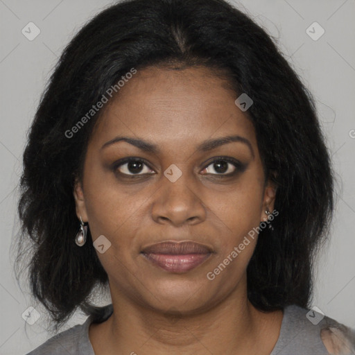 Joyful black young-adult female with long  brown hair and brown eyes