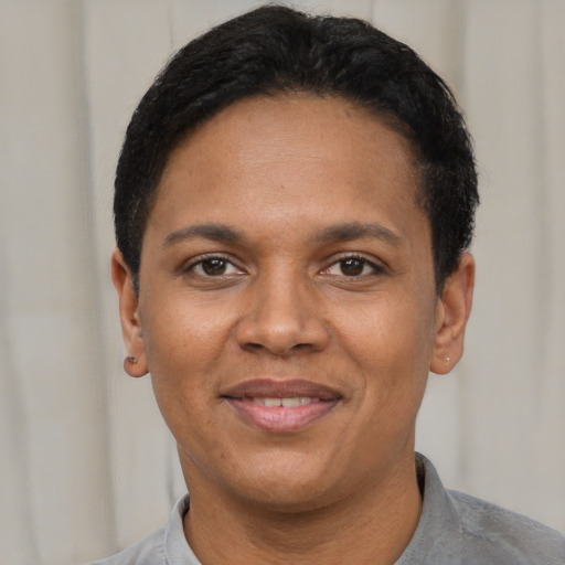 Joyful black adult female with short  black hair and brown eyes