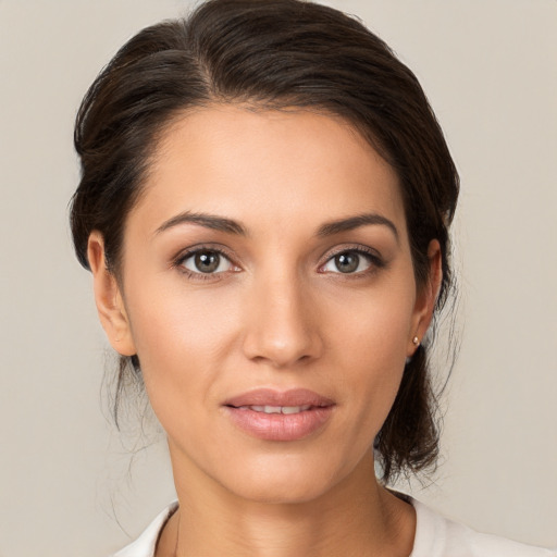 Joyful white young-adult female with medium  brown hair and brown eyes