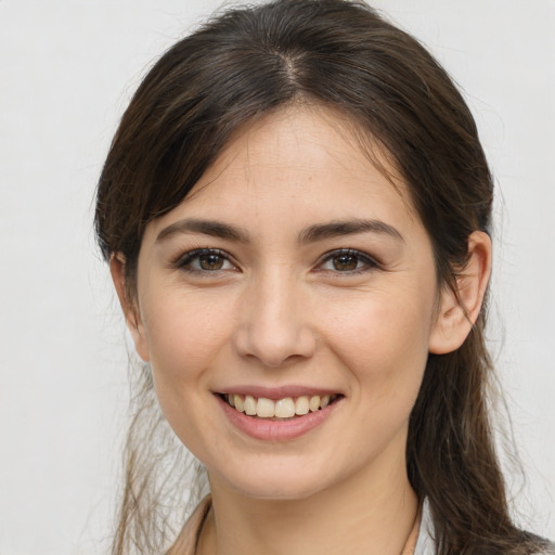 Joyful white young-adult female with medium  brown hair and brown eyes