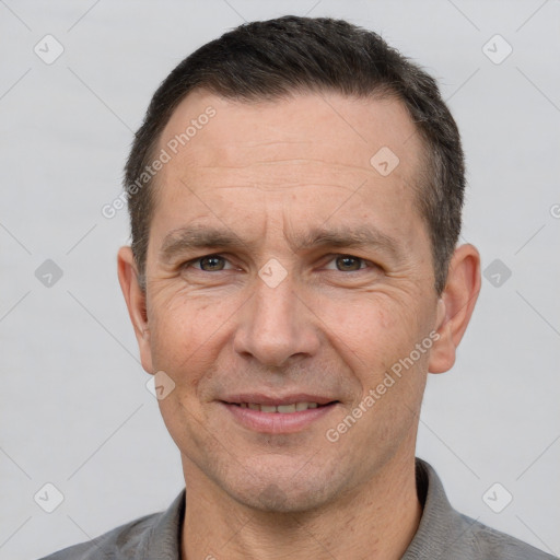 Joyful white adult male with short  brown hair and brown eyes