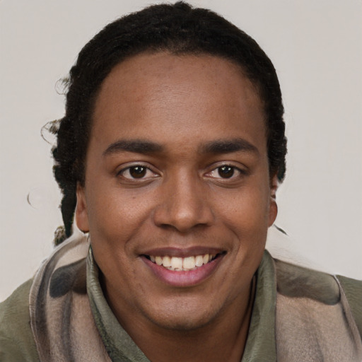 Joyful black young-adult male with short  brown hair and brown eyes