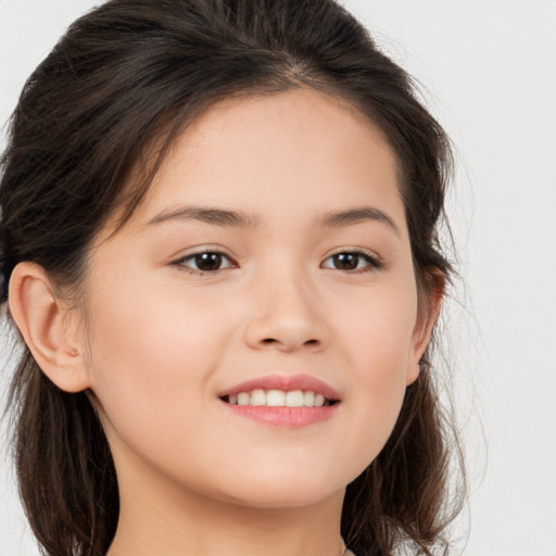 Joyful white child female with long  brown hair and brown eyes