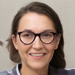 Joyful white adult female with medium  brown hair and blue eyes