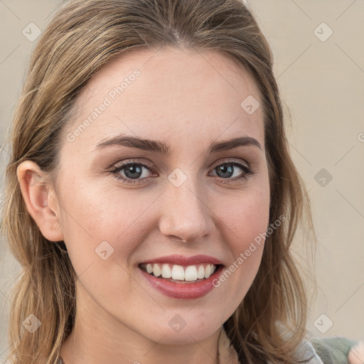 Joyful white young-adult female with long  brown hair and blue eyes