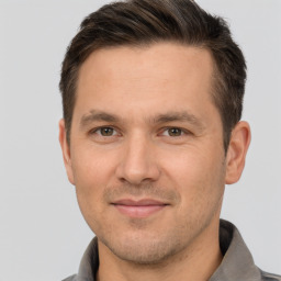 Joyful white adult male with short  brown hair and brown eyes