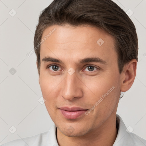 Joyful white young-adult male with short  brown hair and brown eyes