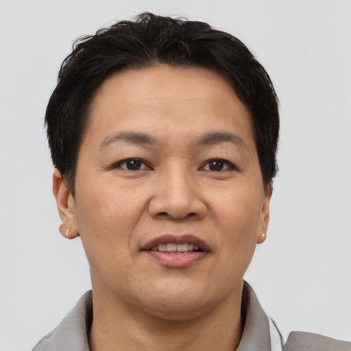 Joyful asian adult female with short  brown hair and brown eyes