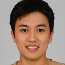 Joyful asian young-adult male with short  black hair and brown eyes