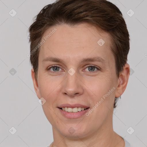 Joyful white adult female with short  brown hair and grey eyes