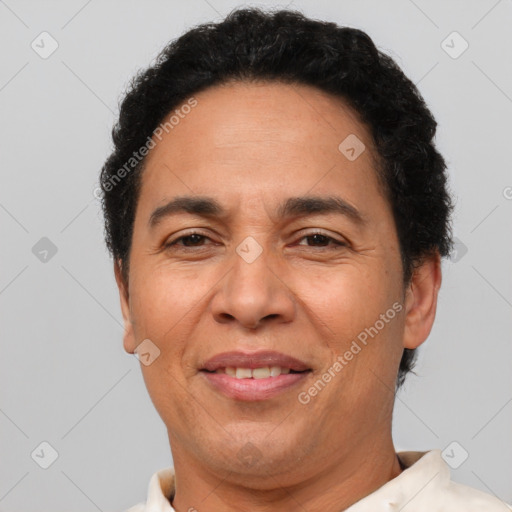 Joyful latino adult male with short  brown hair and brown eyes