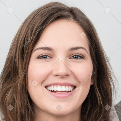 Joyful white young-adult female with long  brown hair and green eyes