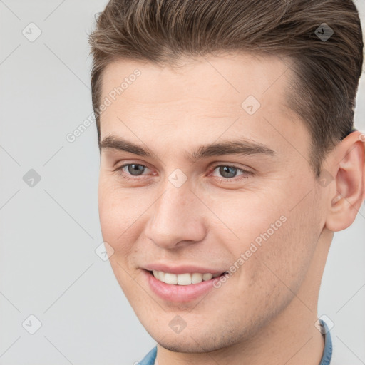 Joyful white young-adult male with short  brown hair and brown eyes