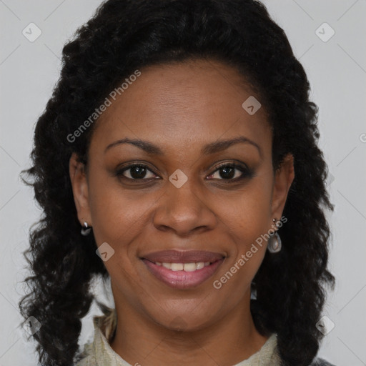Joyful black young-adult female with long  brown hair and brown eyes