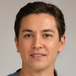 Joyful white adult male with short  brown hair and grey eyes