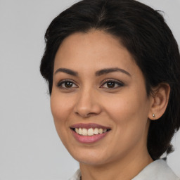 Joyful latino young-adult female with medium  brown hair and brown eyes