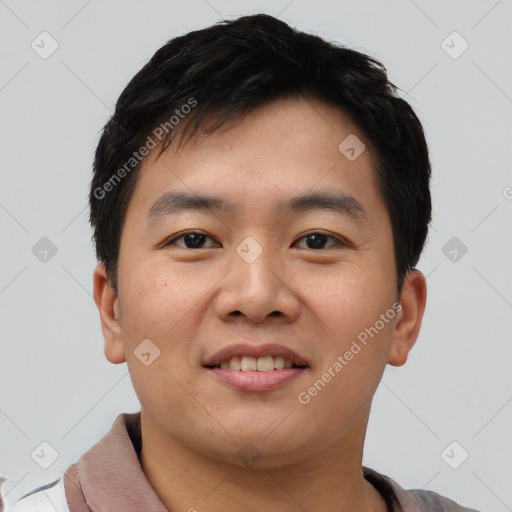 Joyful asian young-adult male with short  black hair and brown eyes