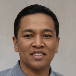 Joyful asian young-adult male with short  black hair and brown eyes