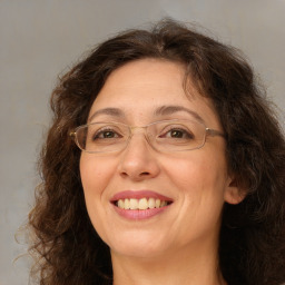 Joyful white adult female with long  brown hair and brown eyes