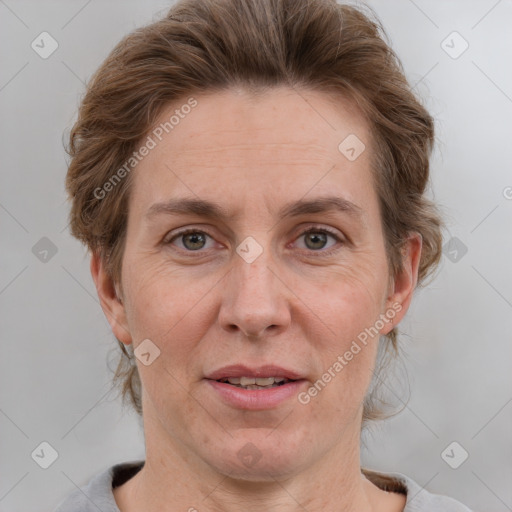 Joyful white adult female with short  brown hair and grey eyes