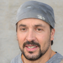 Joyful white adult male with short  black hair and brown eyes