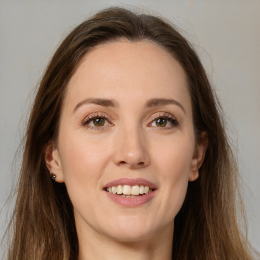 Joyful white young-adult female with long  brown hair and brown eyes