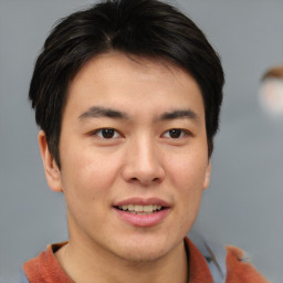 Joyful asian young-adult male with short  brown hair and brown eyes