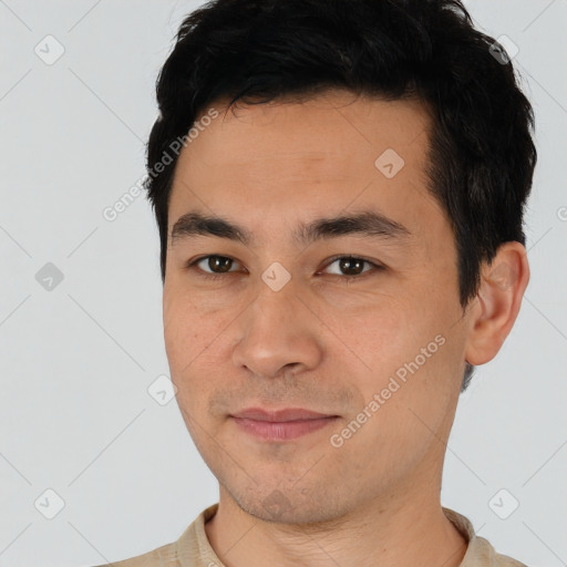 Joyful asian young-adult male with short  black hair and brown eyes