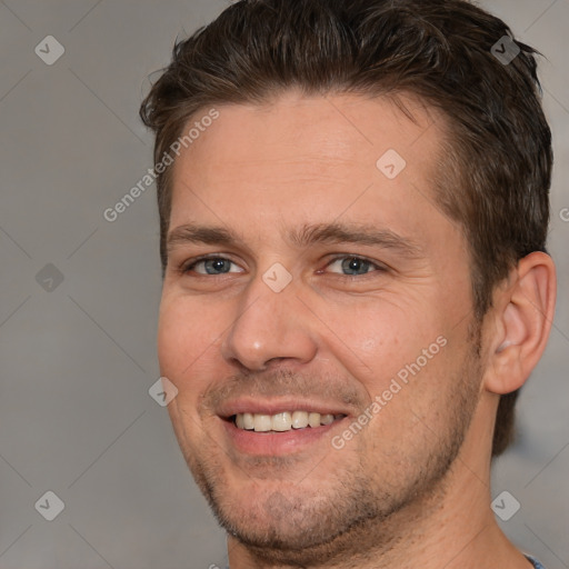 Joyful white adult male with short  brown hair and brown eyes