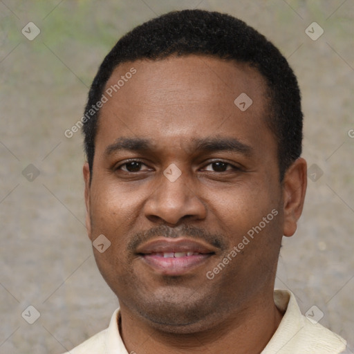 Joyful black adult male with short  black hair and brown eyes