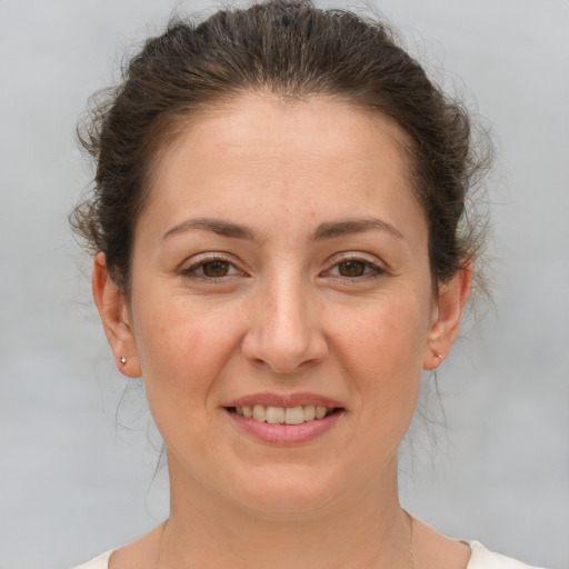Joyful white adult female with short  brown hair and brown eyes