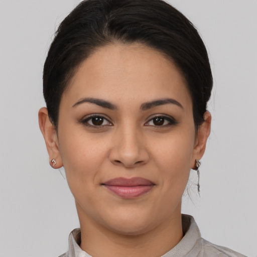 Joyful latino young-adult female with short  brown hair and brown eyes
