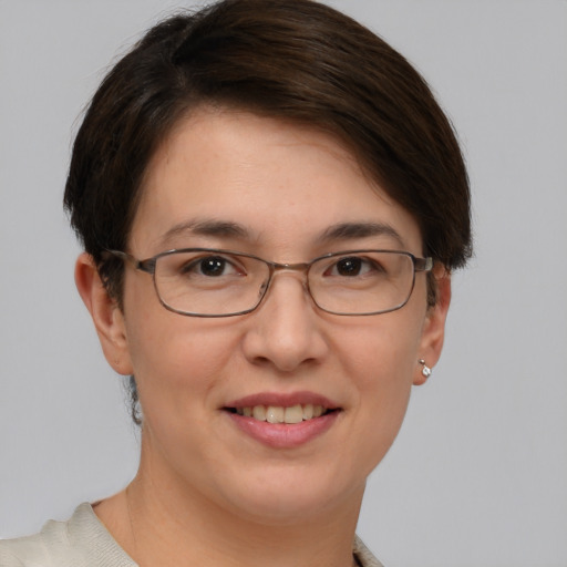 Joyful white adult female with short  brown hair and brown eyes