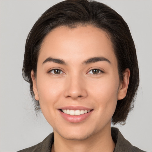 Joyful white young-adult female with medium  brown hair and brown eyes