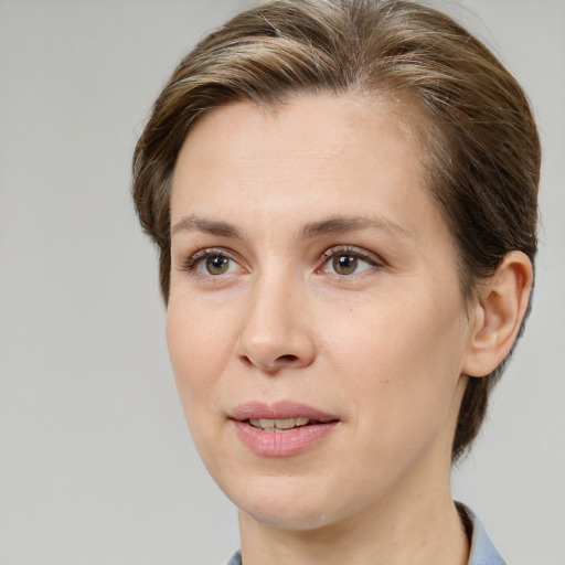 Joyful white young-adult female with medium  brown hair and green eyes