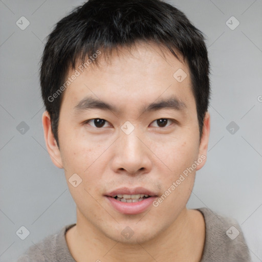 Joyful asian young-adult male with short  brown hair and brown eyes