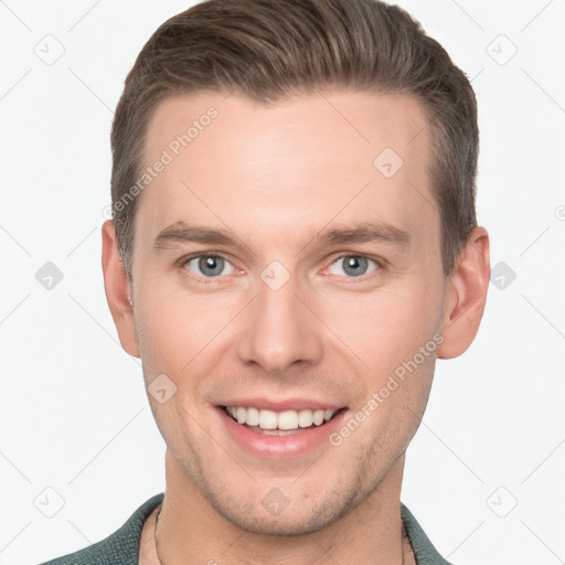 Joyful white young-adult male with short  brown hair and grey eyes