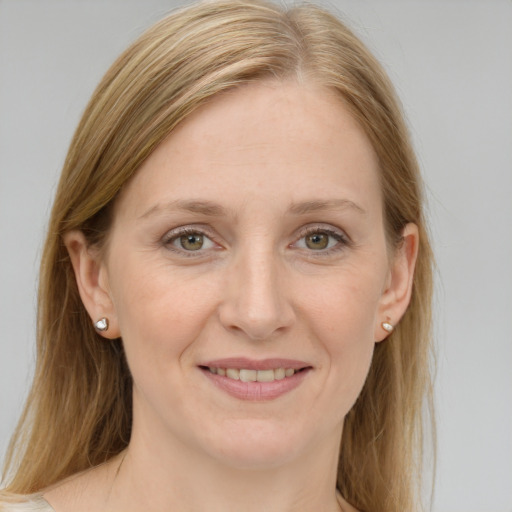 Joyful white young-adult female with medium  brown hair and blue eyes