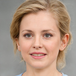 Joyful white young-adult female with medium  brown hair and blue eyes