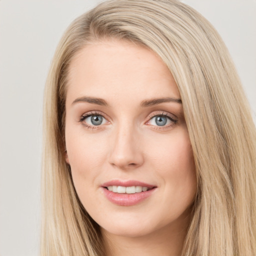 Joyful white young-adult female with long  brown hair and blue eyes