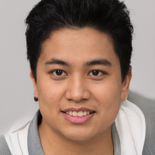 Joyful asian young-adult male with short  brown hair and brown eyes