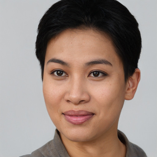 Joyful asian young-adult female with short  black hair and brown eyes