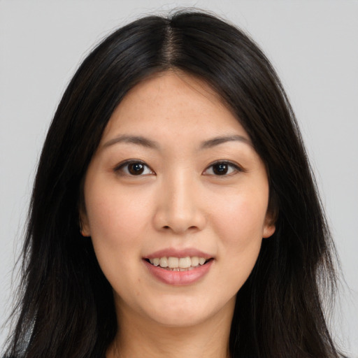 Joyful asian young-adult female with long  brown hair and brown eyes