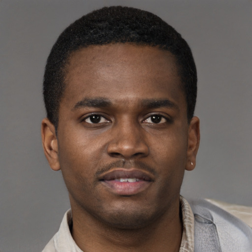 Joyful latino young-adult male with short  brown hair and brown eyes