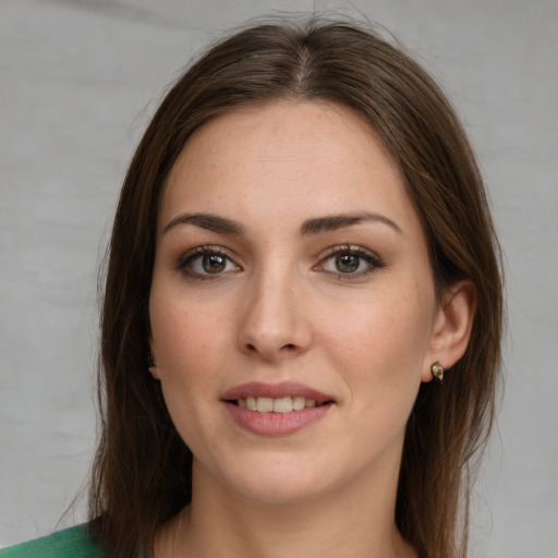 Joyful white young-adult female with long  brown hair and green eyes