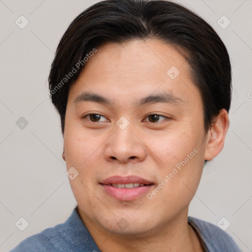 Joyful asian young-adult male with short  brown hair and brown eyes