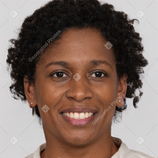 Joyful black adult female with short  brown hair and brown eyes