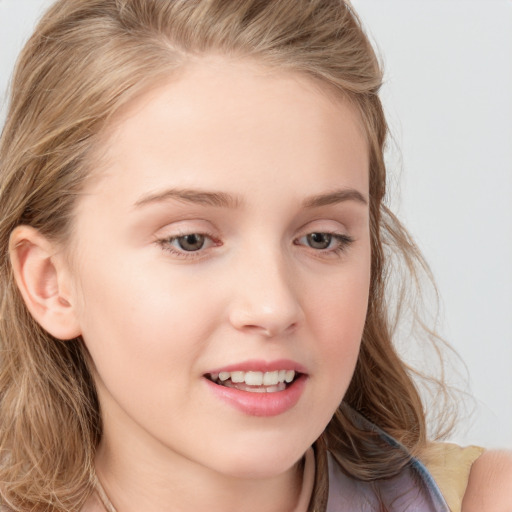 Joyful white child female with long  brown hair and blue eyes