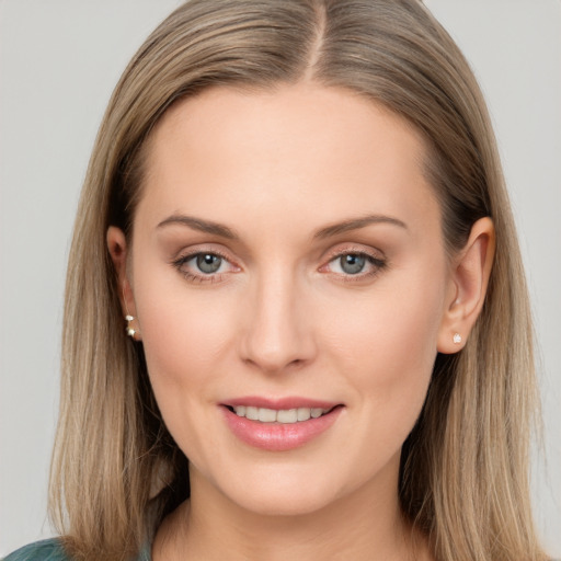 Joyful white young-adult female with long  brown hair and blue eyes