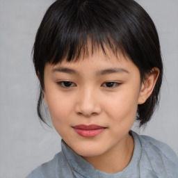 Joyful asian child female with medium  brown hair and brown eyes